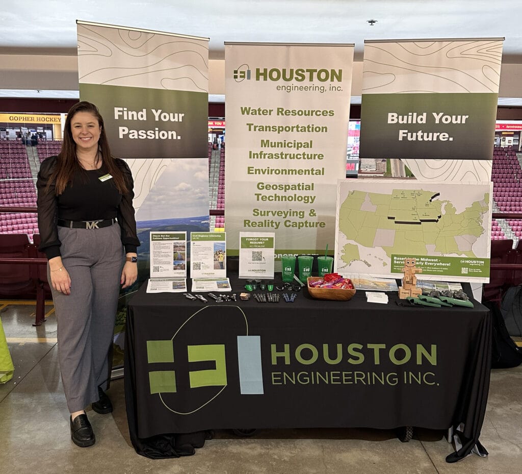 HEI career fair booth with team member