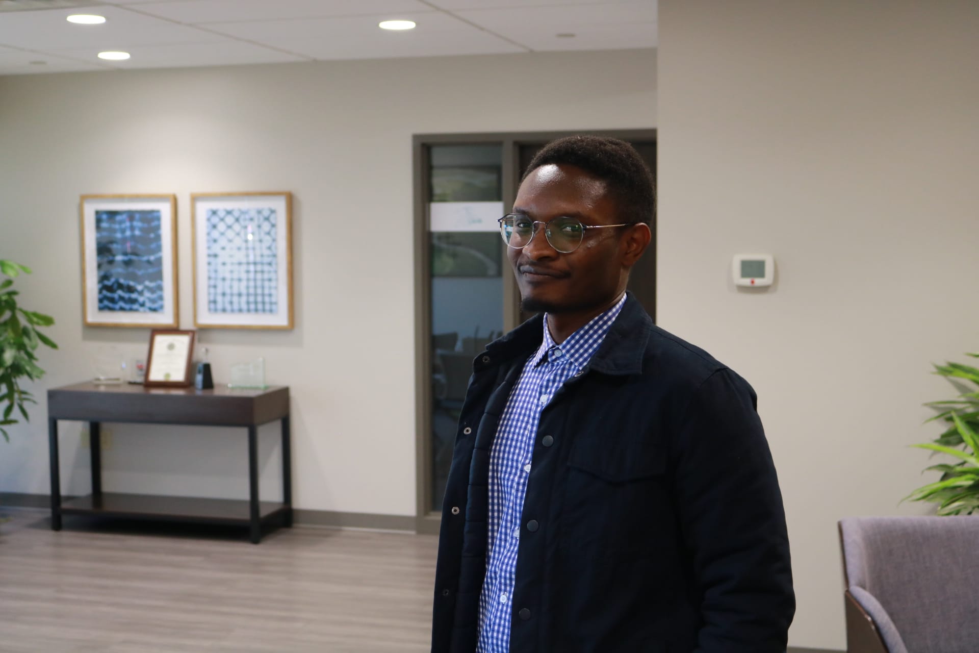 Man standing in modern office space.